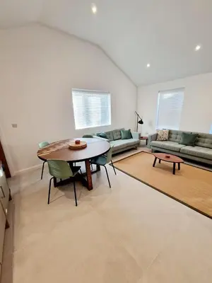a living room with a table and a couch at The Old Bakehouse in Ulverston