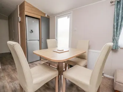 a small dining room with a table and chairs at FGH Holidays in Morecambe