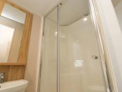 a bathroom with a shower and a sink at FGH Holidays in Morecambe