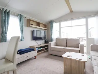 a living room with a couch and a tv at FGH Holidays in Morecambe