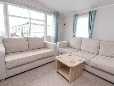 a living room with a couch and a coffee table at FGH Holidays in Morecambe