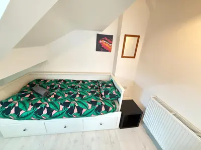 a bedroom with a bed with a green blanket at Holm from Home sleeps 10 in Blackpool