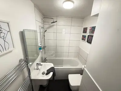 a bathroom with a tub and a sink and a toilet at Holm from Home sleeps 10 in Blackpool