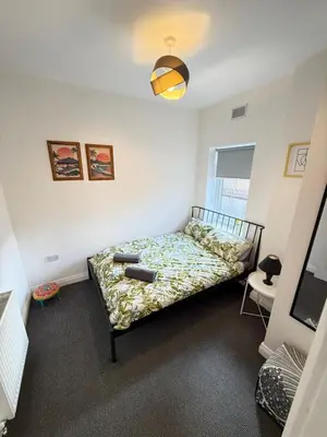 a bedroom with a bed in the corner of a room at Holm from Home sleeps 10 in Blackpool