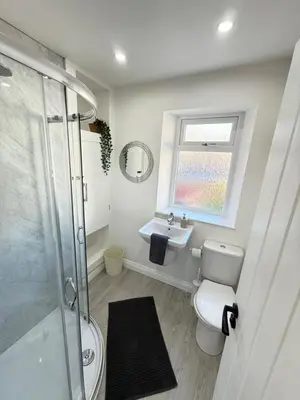 a bathroom with a shower and a toilet and a sink at Holm from Home sleeps 10 in Blackpool