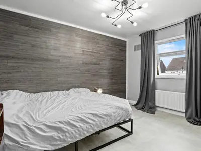 a bedroom with a large bed and a window at Spacious 3 Bedroom Home in Aintree in Liverpool