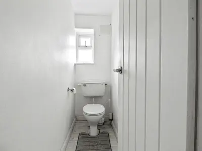 a bathroom with a white toilet in a room at Spacious 3 Bedroom Home in Aintree in Liverpool