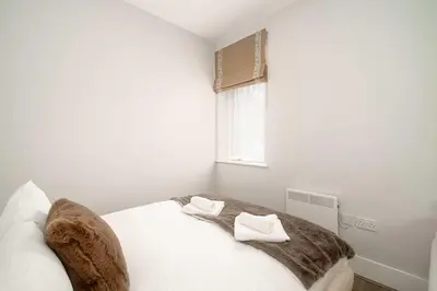 a bedroom with a bed with two towels on it at Modern Studio Apartment in Waterloo Liverpool in Liverpool
