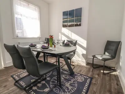 a dining room with a table and chairs at Harbour Mews in Lytham St Annes