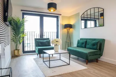 a living room with two green chairs and a table at Oriel Suite - Central - Contractors - 6 Beds in Liverpool