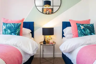 a bedroom with two beds and a table with a lamp at Oriel Suite - Central - Contractors - 6 Beds in Liverpool