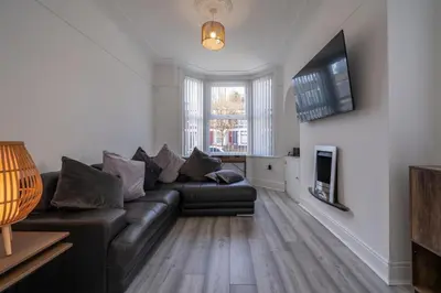a living room with a couch and a tv at The place I remember in Liverpool