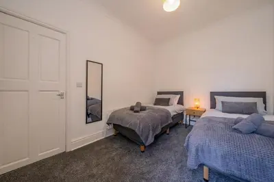 a bedroom with two beds and a mirror at The place I remember in Liverpool