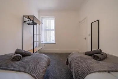 a bedroom with two beds with towels on them at The place I remember in Liverpool