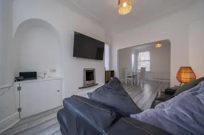 a living room with a couch and a television at The place I remember in Liverpool