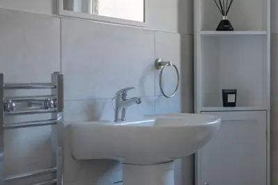a white bathroom with a sink and a window at The place I remember in Liverpool