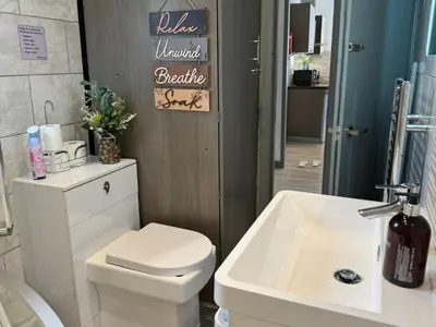 a bathroom with a white toilet and a sink at J's Place in Blackpool