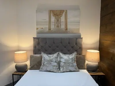 a bedroom with a bed with two lamps at J's Place in Blackpool