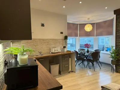 a kitchen and dining room with a table and chairs at J's Place in Blackpool
