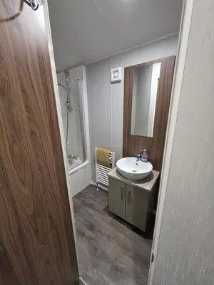 a bathroom with a sink and a mirror at Tw Luxury Caravan in Longridge