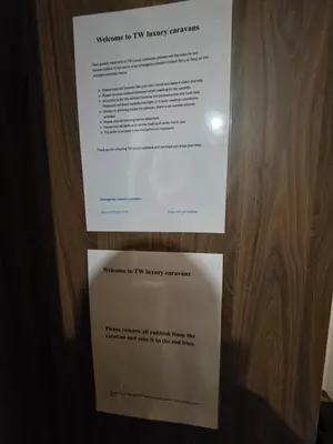 a piece of paper on the door of a room at Tw Luxury Caravan in Longridge