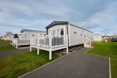 a tiny house with a porch and a yard at Host & Stay - Grange in Morecambe
