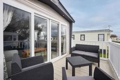 a balcony with chairs and a bench and a table at Host & Stay - Grange in Morecambe