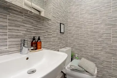 a bathroom with a white sink and a toilet at Richmond Terrace - Cosy and Modern Stay in Darwen