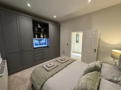 a bedroom with a bed with two towels on it at Full Apartment with secure parking great views in Preston