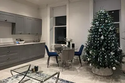 a christmas tree in a kitchen with a table and chairs at Full Apartment with secure parking great views in Preston
