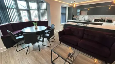 a living room with a couch and a table at Luxury Seaside Apartments with Free Parking in Blackpool
