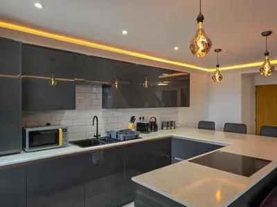 a kitchen with black cabinets and a counter top at Luxury Seaside Apartments with Free Parking in Blackpool