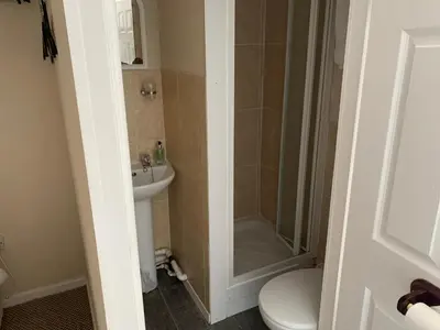 a bathroom with a shower and a toilet and a sink at Sharn Bek Hotel in Blackpool