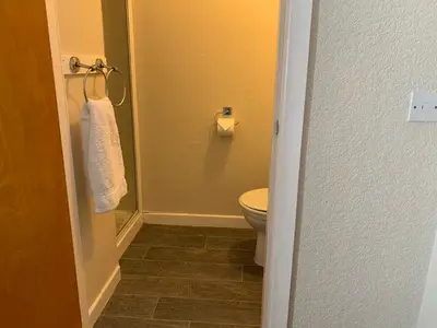 a bathroom with a toilet and a towel at Sharn Bek Hotel in Blackpool