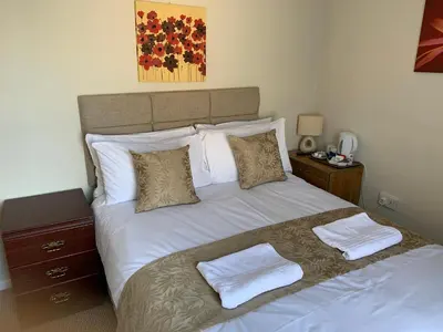 a bedroom with a bed with two towels on it at Sharn Bek Hotel in Blackpool
