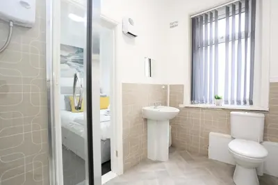 a bathroom with a toilet and a sink and a shower at Avalanche 1 Bed Apartment in Blackpool