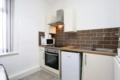a kitchen with a sink and a microwave at Avalanche 1 Bed Apartment in Blackpool