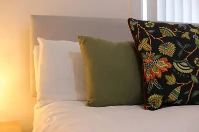a bed with two pillows on top of it at Big Dipper 2 Bed Pleasure Beach in Blackpool
