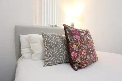 two pillows sitting on top of a bed at Big Dipper 2 Bed Pleasure Beach in Blackpool
