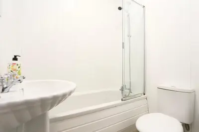 a white bathroom with a sink and a toilet at Grand National 1-Bed Very Close to Pleasure Beach in Blackpool