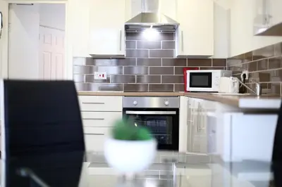 a kitchen with a stove and a microwave at Grand National 1-Bed Very Close to Pleasure Beach in Blackpool
