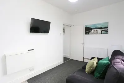 a living room with a couch and a flat screen tv at Ice Blast 1 Bed Pleasure Beach in Blackpool