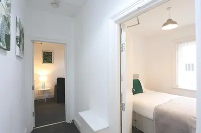 a bedroom with a bed and a door leading into a room at Ice Blast 1 Bed Pleasure Beach in Blackpool