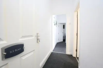 a hallway with a sign that says ice music in a room at Ice Blast 1 Bed Pleasure Beach in Blackpool