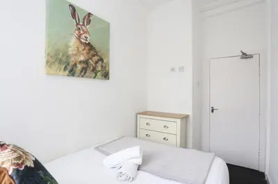 a bedroom with a painting of a deer on the wall at Pepsi Max 3 Bed Apartment 2 Bathroom close to Pleasure Beach in Blackpool