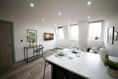 a kitchen with a table and chairs in a room at Spacious 2 Bedroom Apartment in Central Preston in Preston