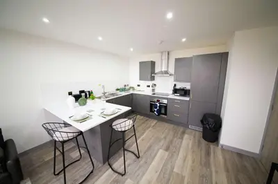 a kitchen with a white table and two chairs at Spacious 2 Bedroom Apartment in Central Preston in Preston