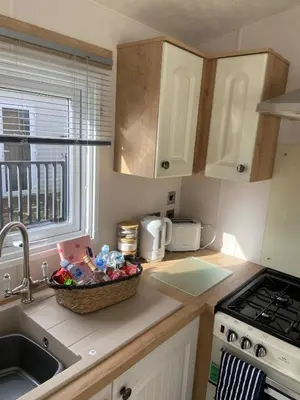 a kitchen with a sink and a basket of food on the counter at Westfield Lodge Retreat-Sleeps 6-Pet Friendly in Carnforth