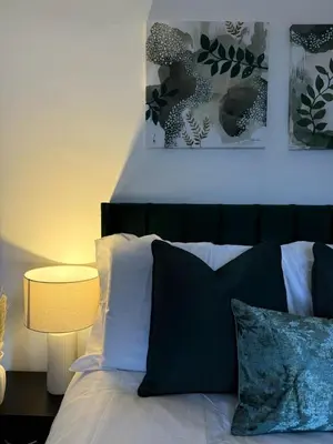 a bedroom with a bed with black and white pillows at 3BR Accommodation in St Helens - Sleeps 6 in Saint Helens