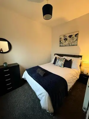 a bedroom with a bed and a mirror at 3BR Accommodation in St Helens - Sleeps 6 in Saint Helens